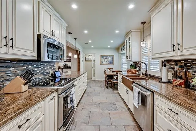 Galley kitchen with granite countertops and copper farmhouse sink