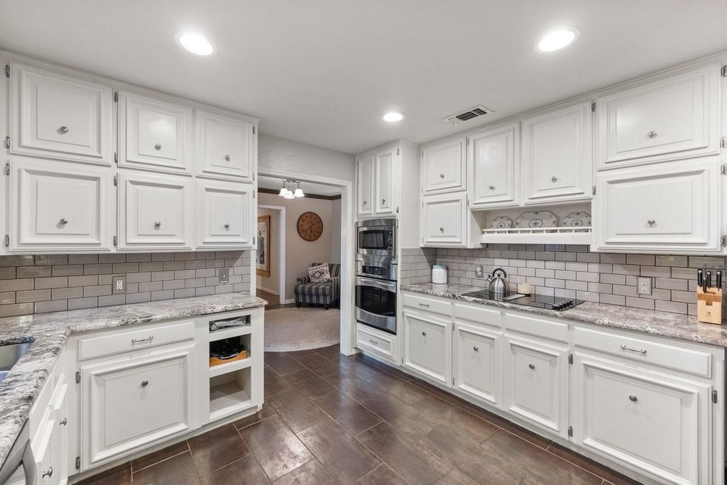 White Kitchen with Granite Counters & Subway Backsplash