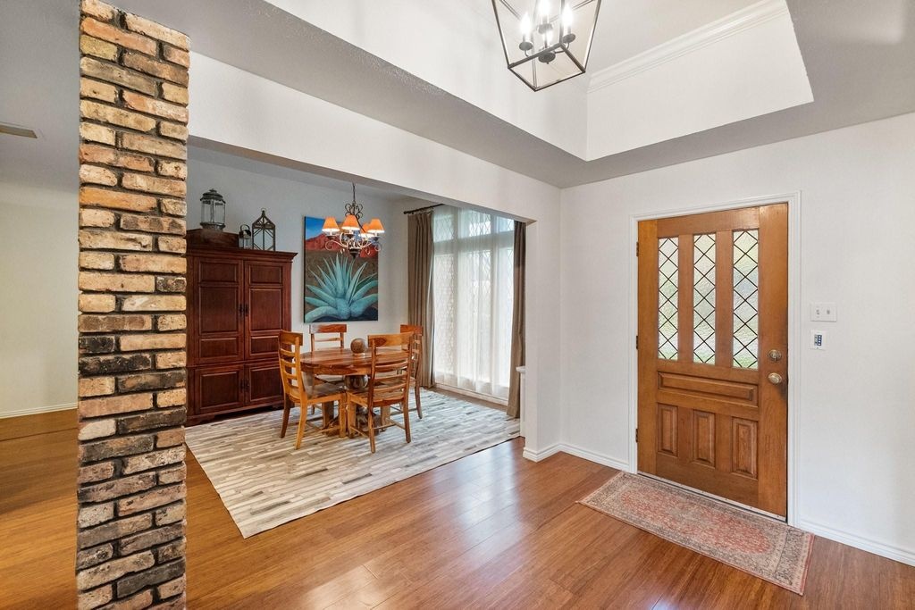 Entry & Dining Room with Brick Column & Hardwoods