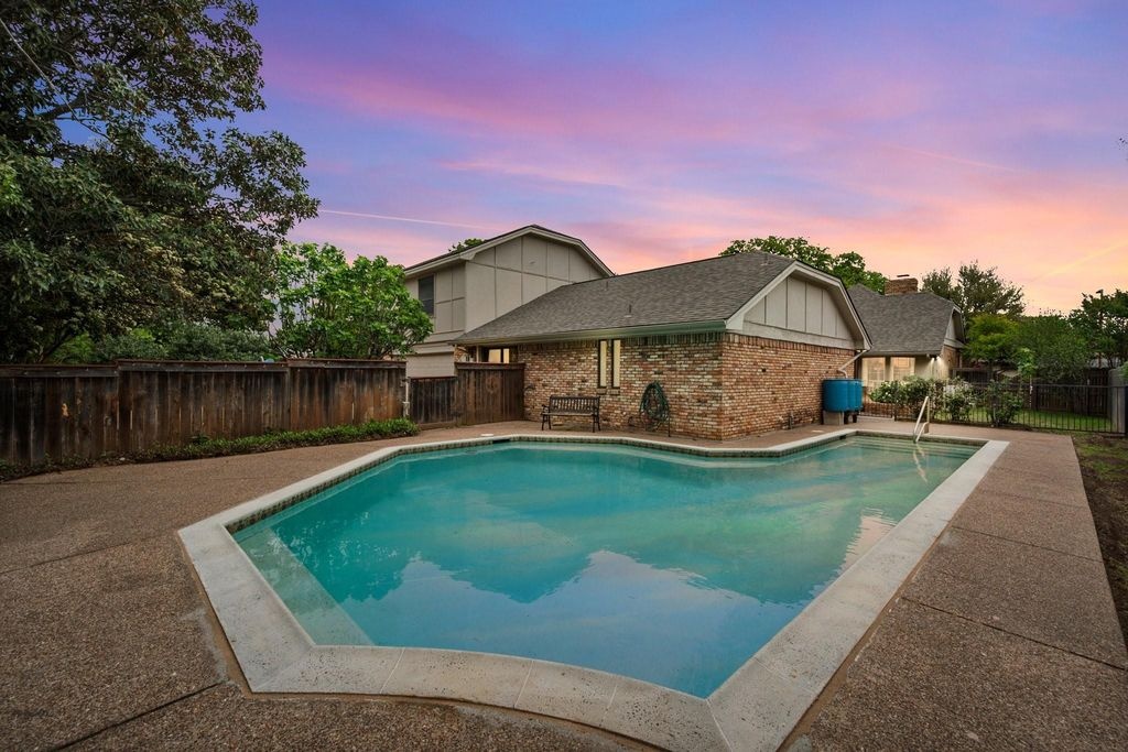 Backyard Pool & Brick Home at Sunset